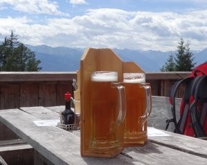 2 beers with wooden sunshades & a vew of mountain tops in the far distance