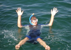 Snorkeler in the water waving