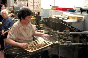 Lady making fortune cookies in Chinatown, San Francisco